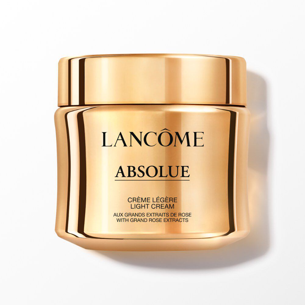 The Lancome absolue light cream comes in a golden jar with a screw-on lid.